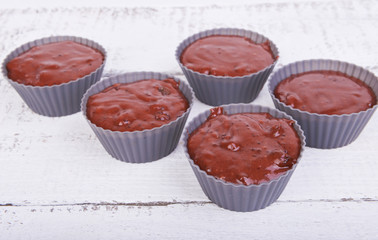 The dough for chocolate cakes muffins in silicone