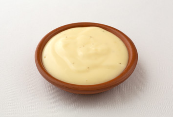 Bowl of blue cheese salad dressing on tablecloth