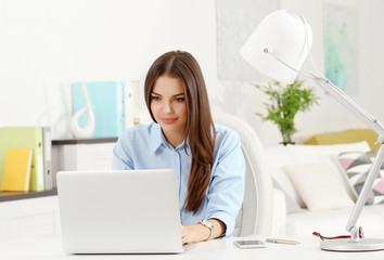 A beautiful successful woman working at the modern office