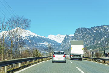 View of road with car and truck in winter Switzerland