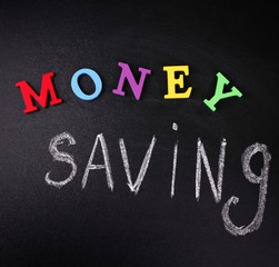 Money saving concept on a blackboard background