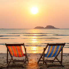 Couple of loungers on sea beach.