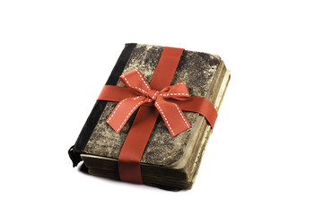 old vintage book in a gift ribbon isolated on white
