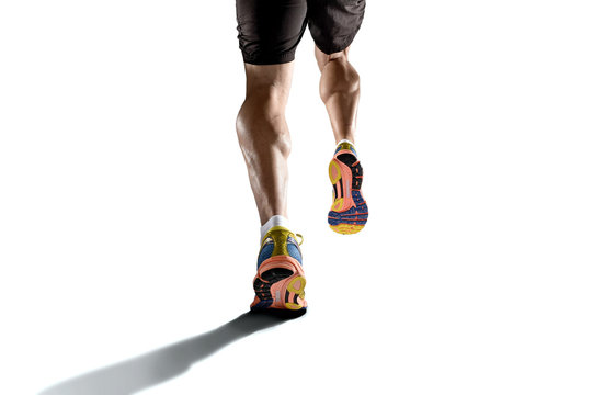 strong athletic legs with ripped calf muscle of young sport man running isolated on white background