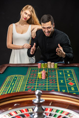 Couple playing roulette wins at the casino.