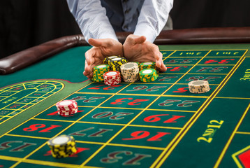 Picture of a green table and betting with chips.