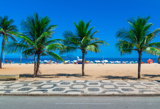 Ipanema beach with palms and mosaic of sidewalk in Rio de Janeiro. Brazil