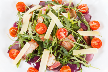 Fresh salad with bacon, tomatoes, parmesan and arugula