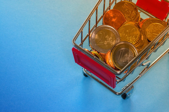 A shopping cart with euro coins, symbolic photo for purchasing