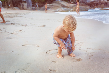 Toddler walking on a beach