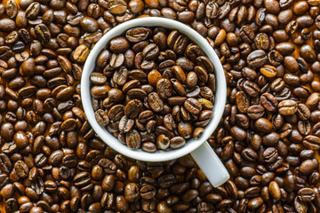 Cup of Coffee on and with Coffee Beans