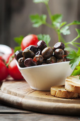 Olive with tamato and parsley on the wooden table