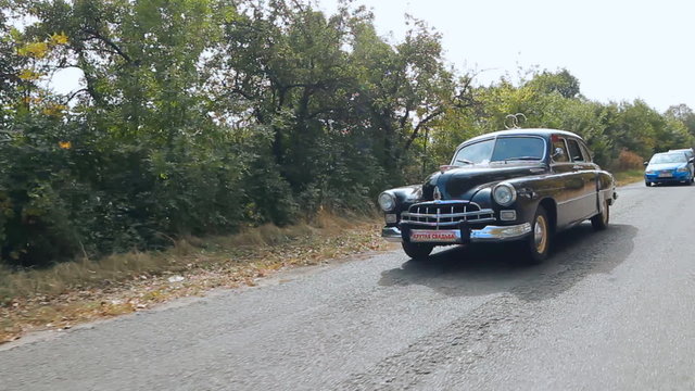 Marriage, wedding procession. Wedding old car on the autumn road 