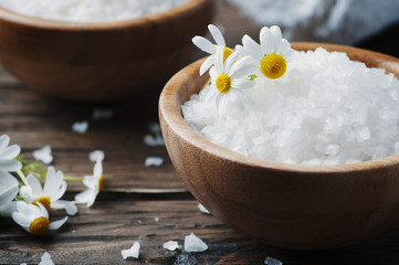 Fototapeta na wymiar Concept of spa treatment with salt and daisy