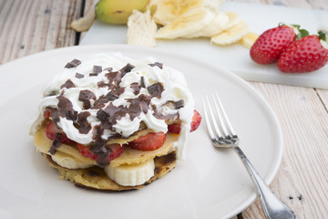 pancakes with strawberries, banana, blueberries and chocolate...