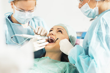 Fototapeta premium Dentists with a patient during a dental intervention.