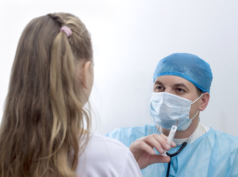 Doctor in his practice with syringe