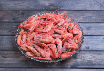 Large glass dish with a large frozen shrimp