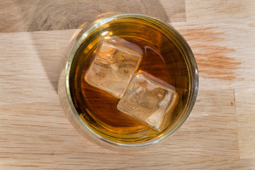 iced wiskey on the wood floor from above
