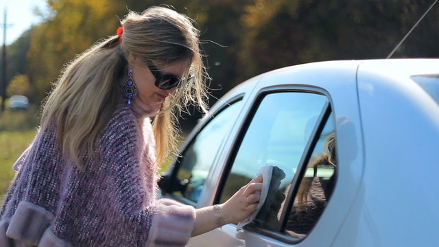 Woman female miss motorist washes car windows. Female driver. Car Care. Miss, lady 