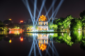 Night view of the Turtle Tower among blue light rays, Hanoi