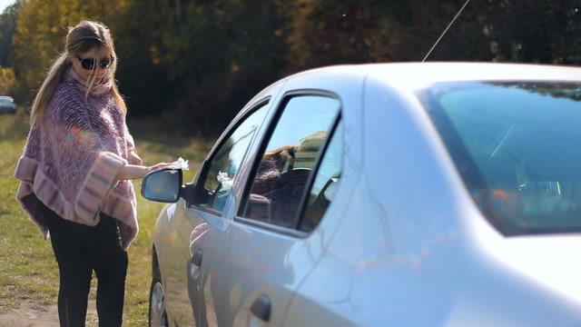 Woman female miss motorist washes car windows. Female driver. Car Care. Miss, lady 