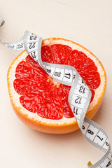 Dieting. Grapefruit with measuring tape
