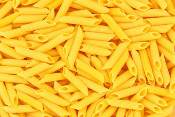 Italian Penne Rigate Macaroni Pasta raw food background or textu