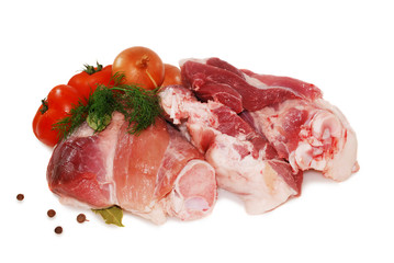 Raw beef meat. Shank steak with fresh vegetables isolated on a white background