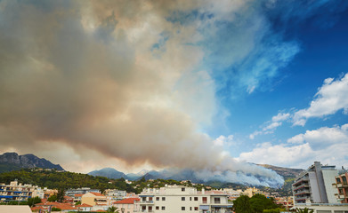 Obraz premium Italy, Ventimiglia, 2015.09.09: Fire in the forest mountain in the Italian town of Ventimiglia, all the mountains in the smoke, the villa is on fire, the fire service aircraft extinguish a fire