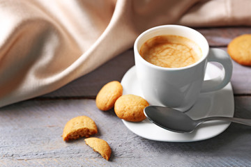 Cup of coffee on wooden table background