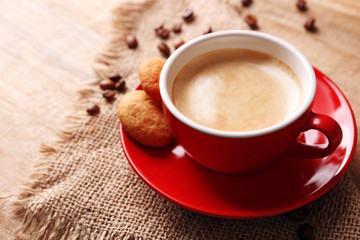 Cup of coffee on wooden table background