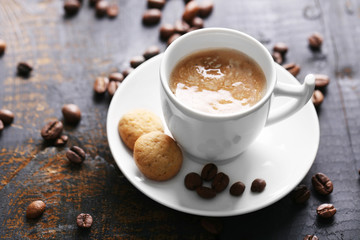 Cup of coffee on wooden table background
