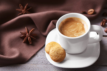 Cup of coffee on wooden table background