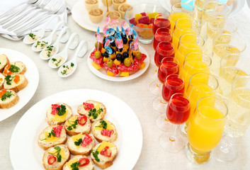 Set of cold snacks, canape, beverages, closeup
