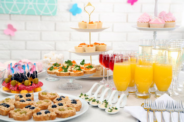 Set of cold snacks, canape, beverages and dessert, closeup