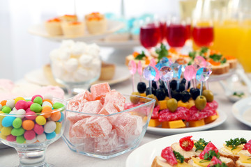 Set of cold snacks, canape, beverages and dessert, closeup