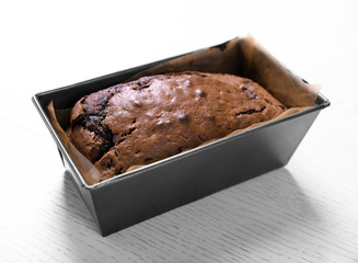 Chocolate cake in baking dish on white table