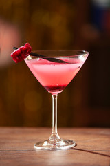 Glass of cocktail on bar background