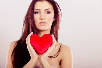 Beautiful woman holds red heart