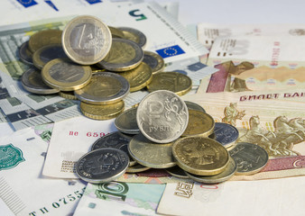 Russian roubles and Euro coins on banknotes