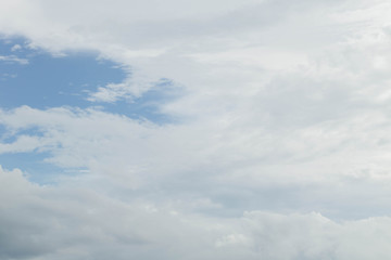 Light blue sky with clouds, may be used as background