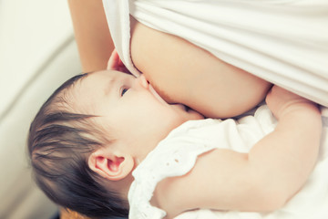 Obraz na płótnie Canvas Soft focus image of newborn baby breastfeeding