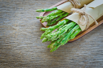 Bunch of fresh asparagus on wooden table