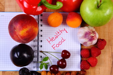 Fruits and vegetables with notebook, slimming and healthy food