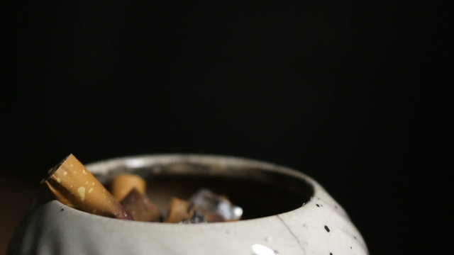 Hand putting out cigarette in ashtray, Multi shot
