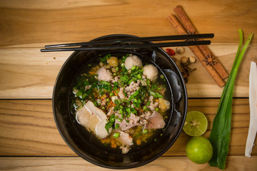 bowl of noodles with vegetables on wooden table. delicious noodl