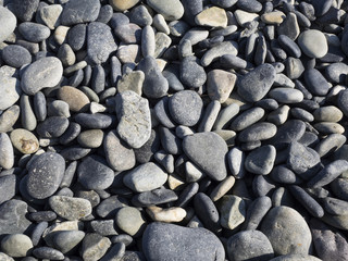 Round stones at the sea, background