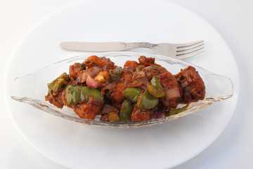 Indian food or Chinese food. Chicken with sweet and sour sauce.
