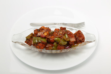 Indian food or Chinese food. Chicken with sweet and sour sauce.